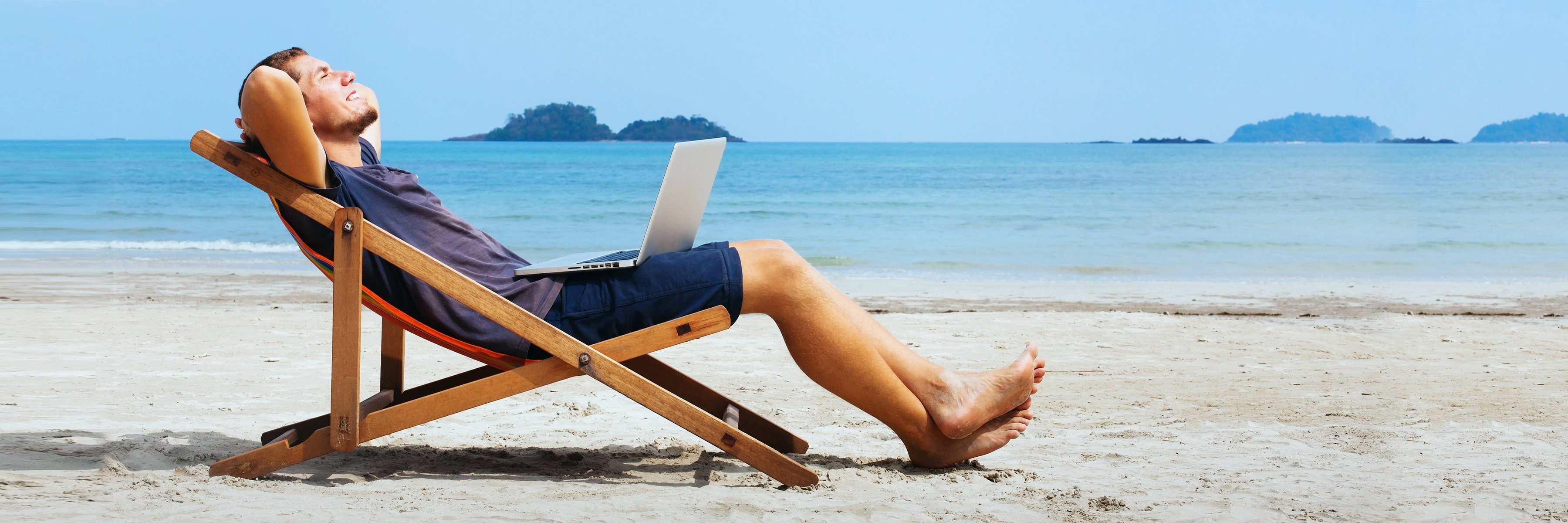 Mężczyzna leży beztrosko na leżaku na plaży.
